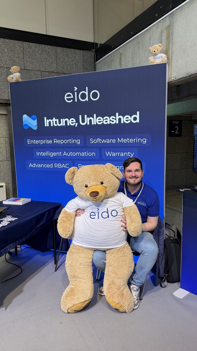 One of the Eido team sitting behind Odie at the stand.