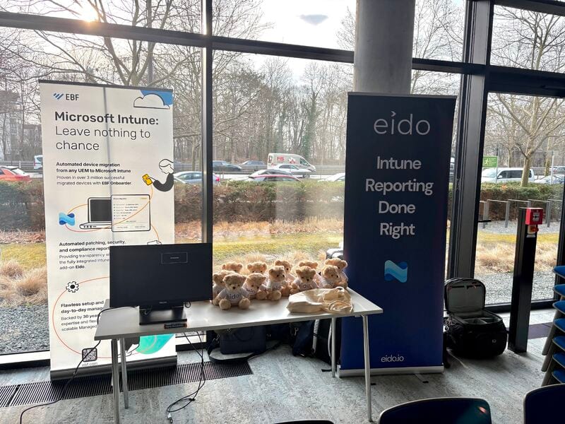 The stand at Workplace Ninjas Germany: an EBF banner, an Eido banner reading Intune reporting done right, and a row of small Odie bears on the table.